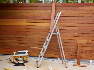 An image of a nearly finished custom wooden fence.